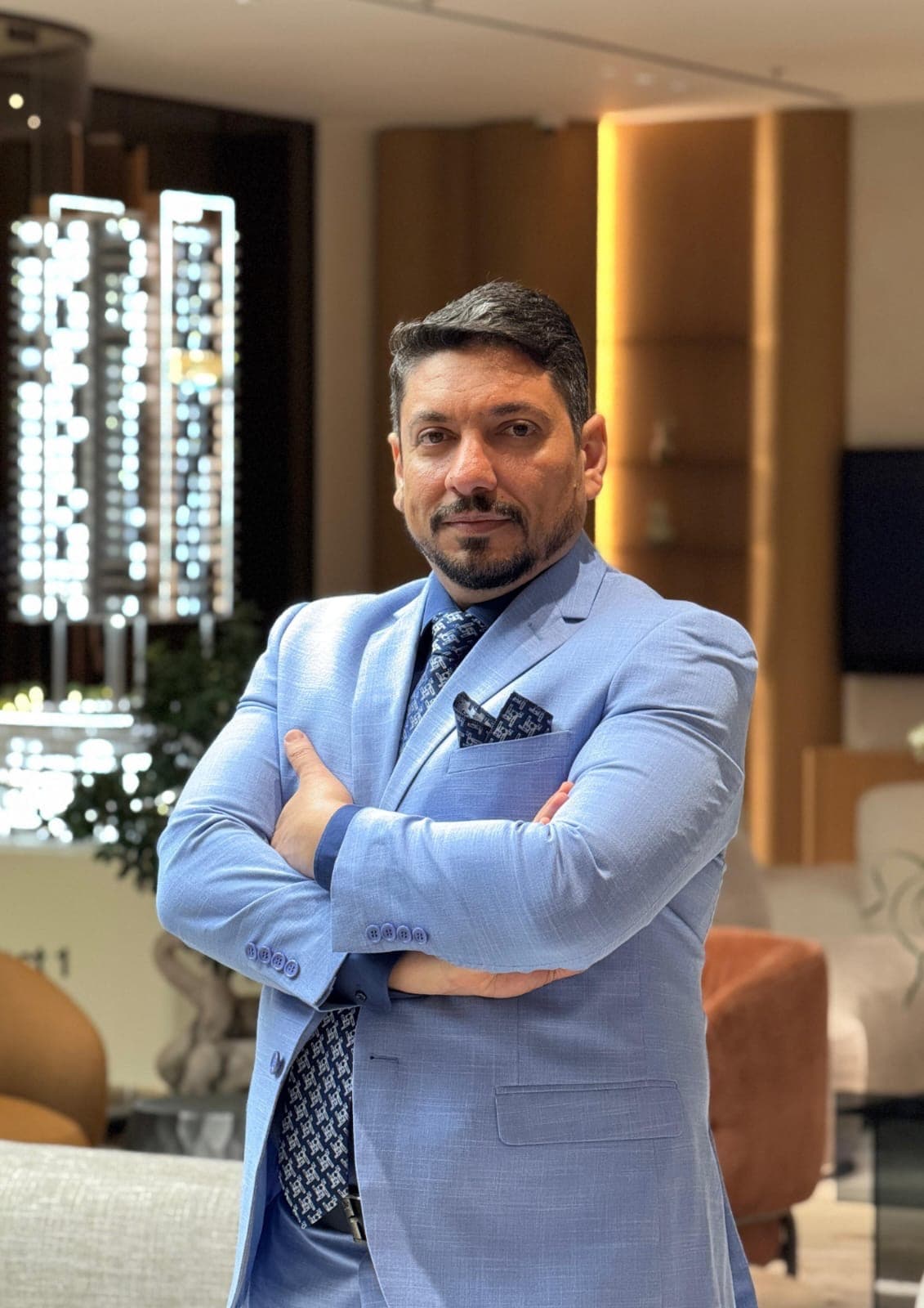 Weeam El Naggar, arms crossed, in a Dubai property sales gallery